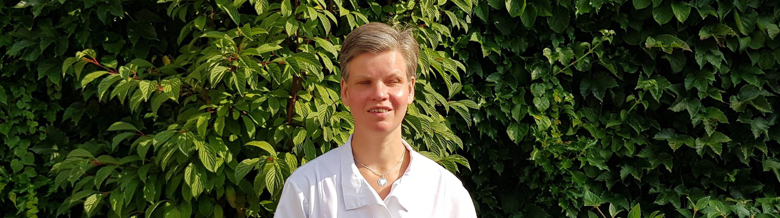 Esther Nijerees-Deterink op achtergrond van planten